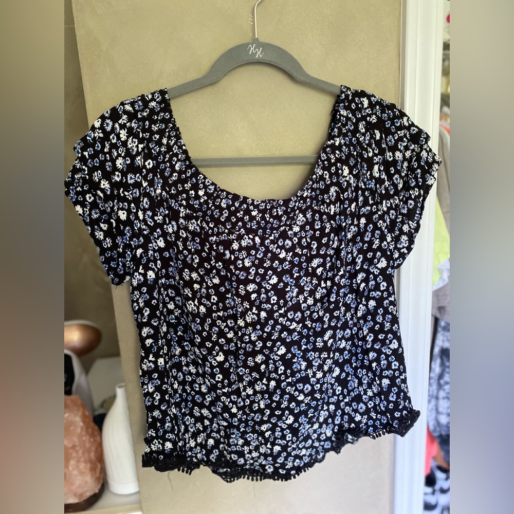 black off the shoulder blouse with blue and white floral print